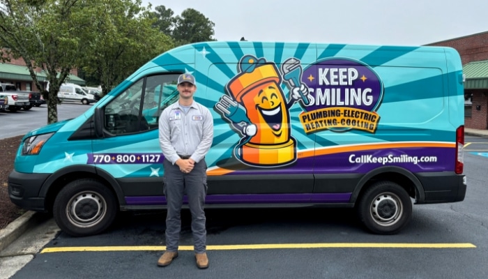Technician Standing With Service Van